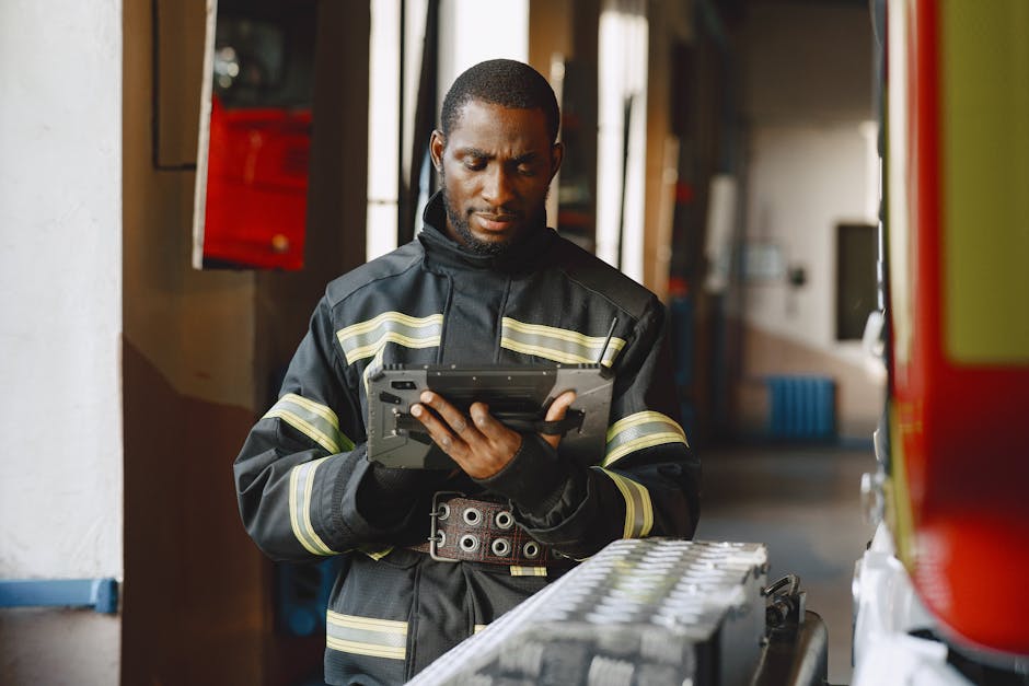 Firefighter using a ruggedized tablet on the fireground