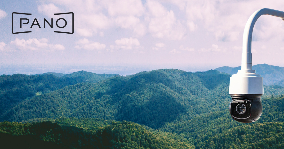 Pano AI wildfire detection camera mounted on tower overlooking forested mountains