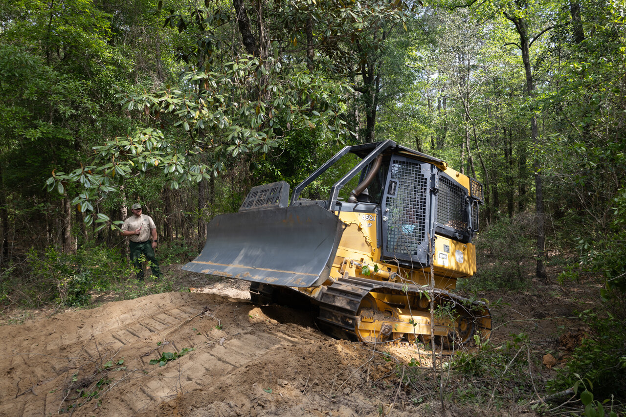Fire bulldozer operator in cab with thermal sensor dashboard display