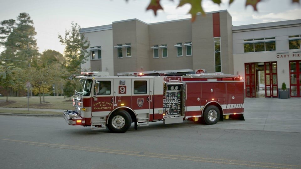 Red Pierce electric fire apparatus at fire station