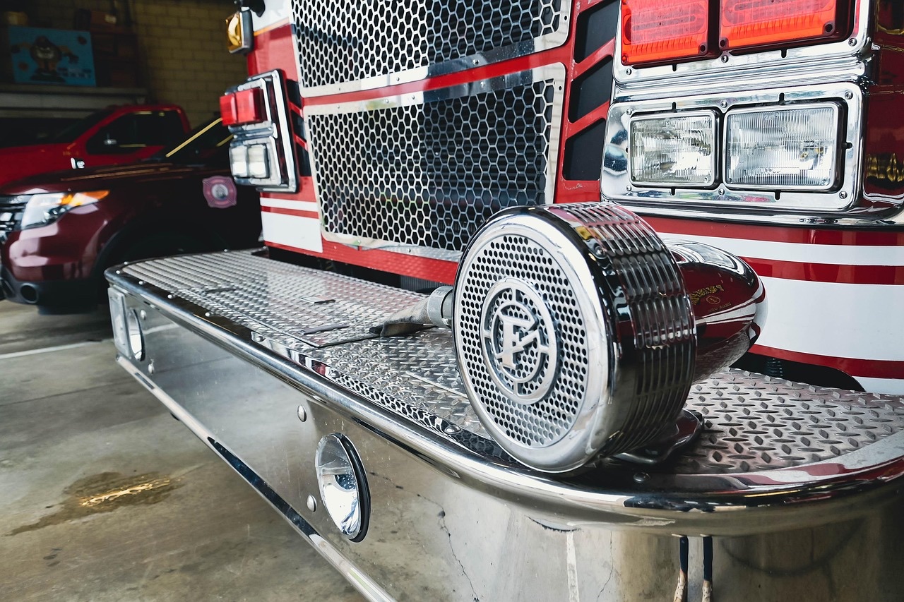 American fire engine and Pierce pumper apparatus inside a fire station bay