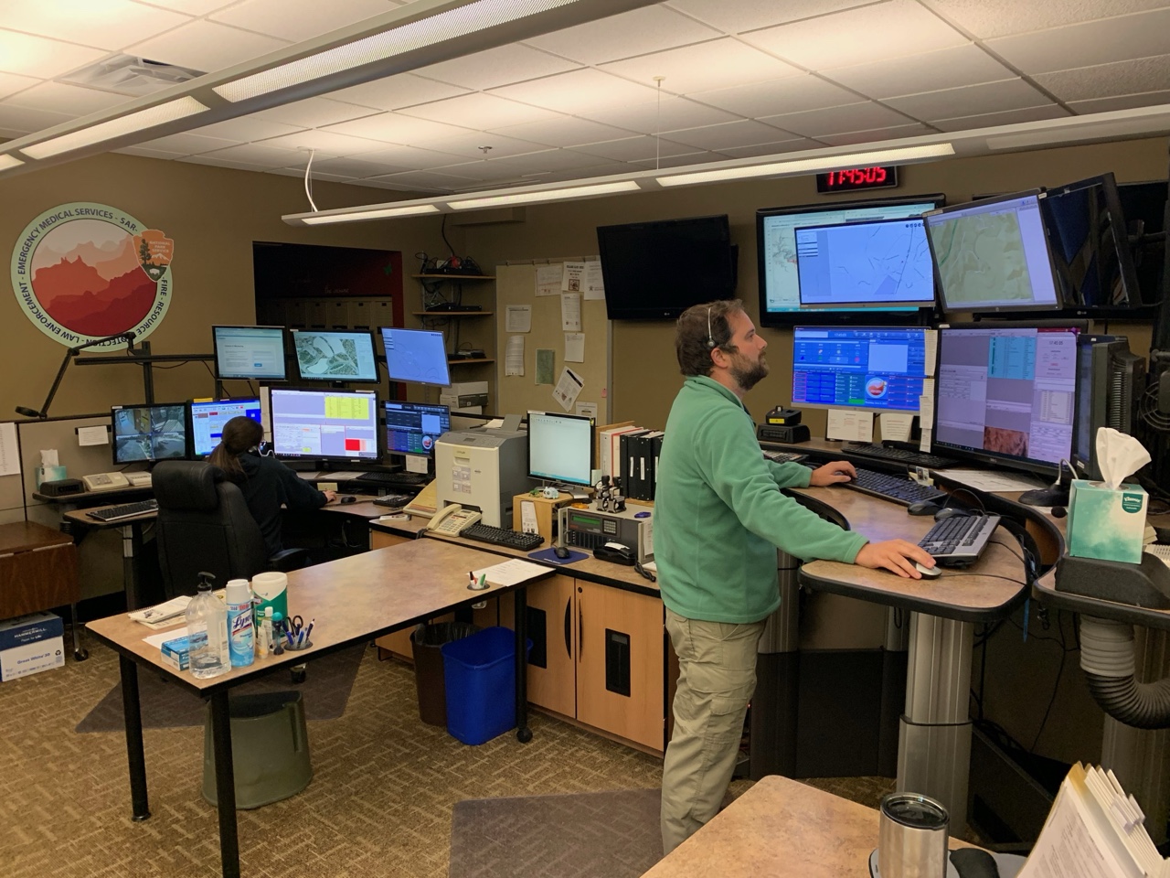 911 dispatch center with operator at multi-monitor console