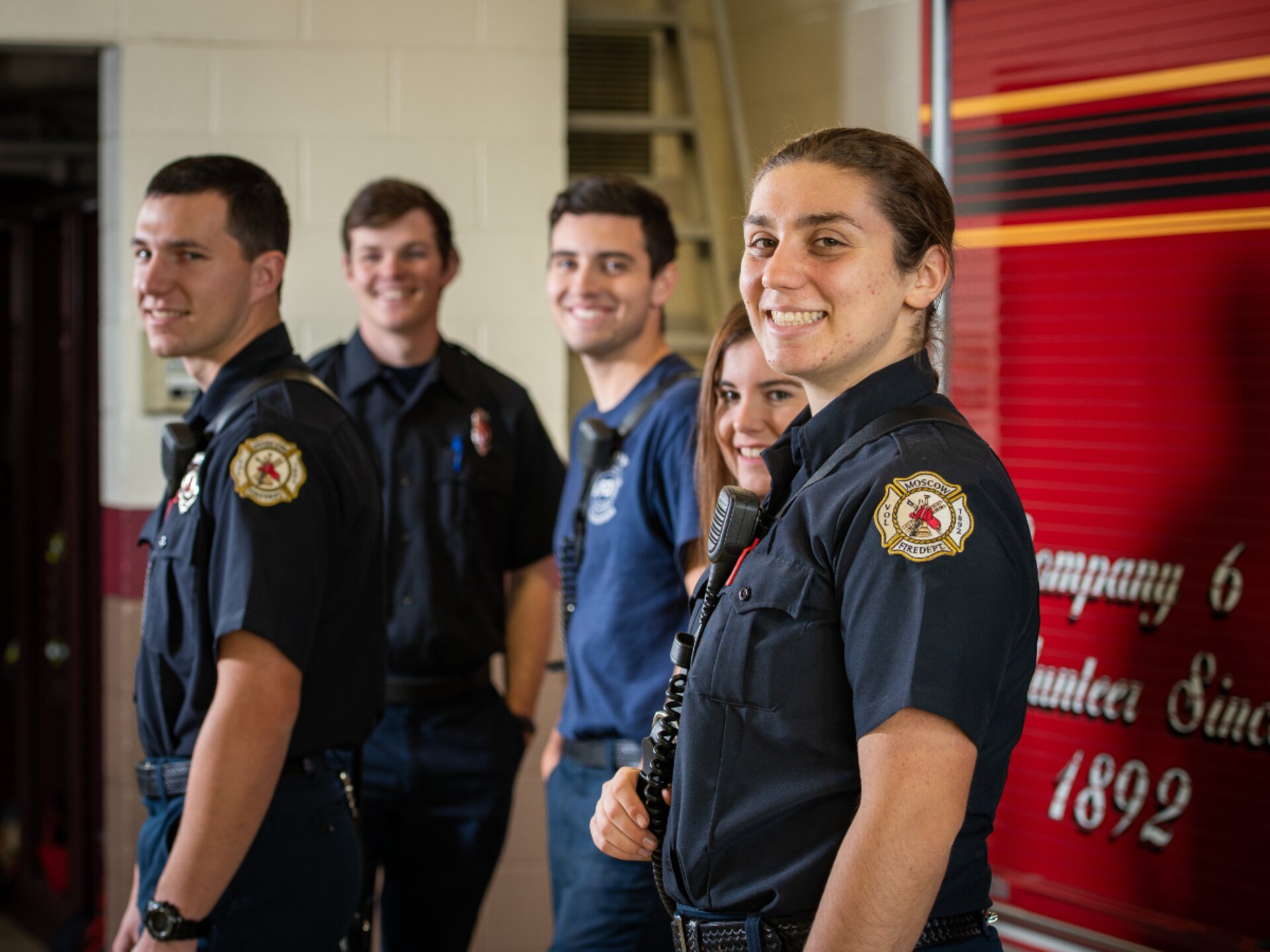 American volunteer firefighter speaking with a community member at a department open house