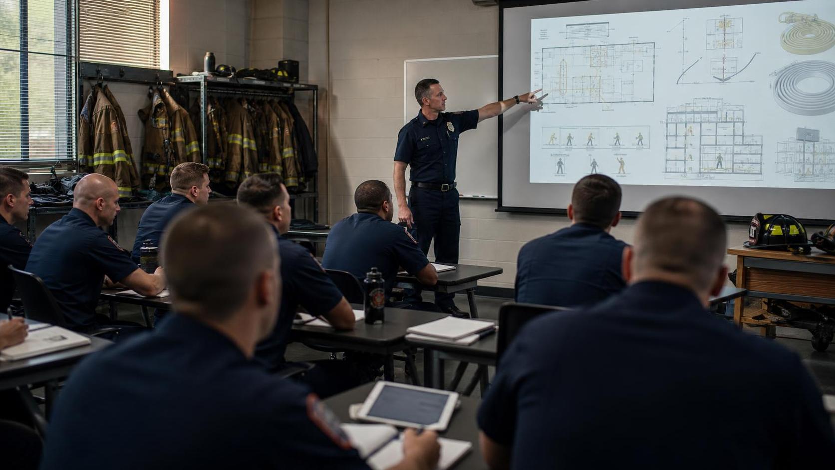 Fire service instructor training a group of new recruits in a classroom setting