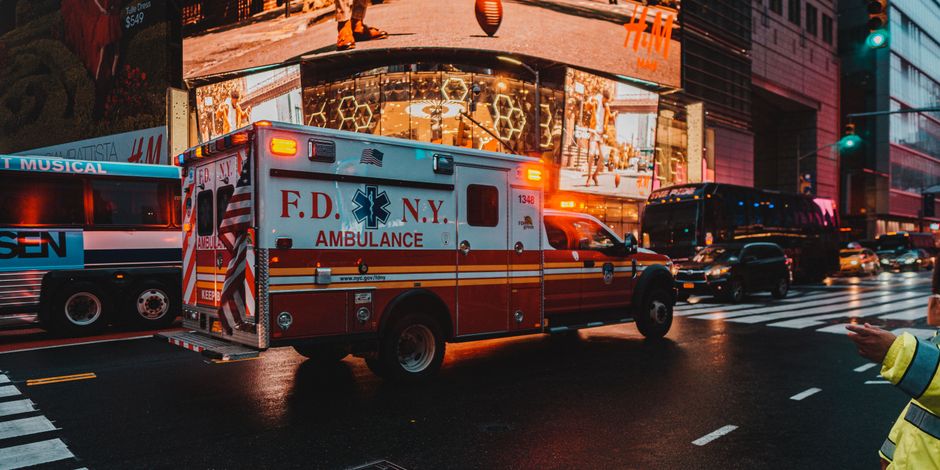 An ambulance on a city road at speed