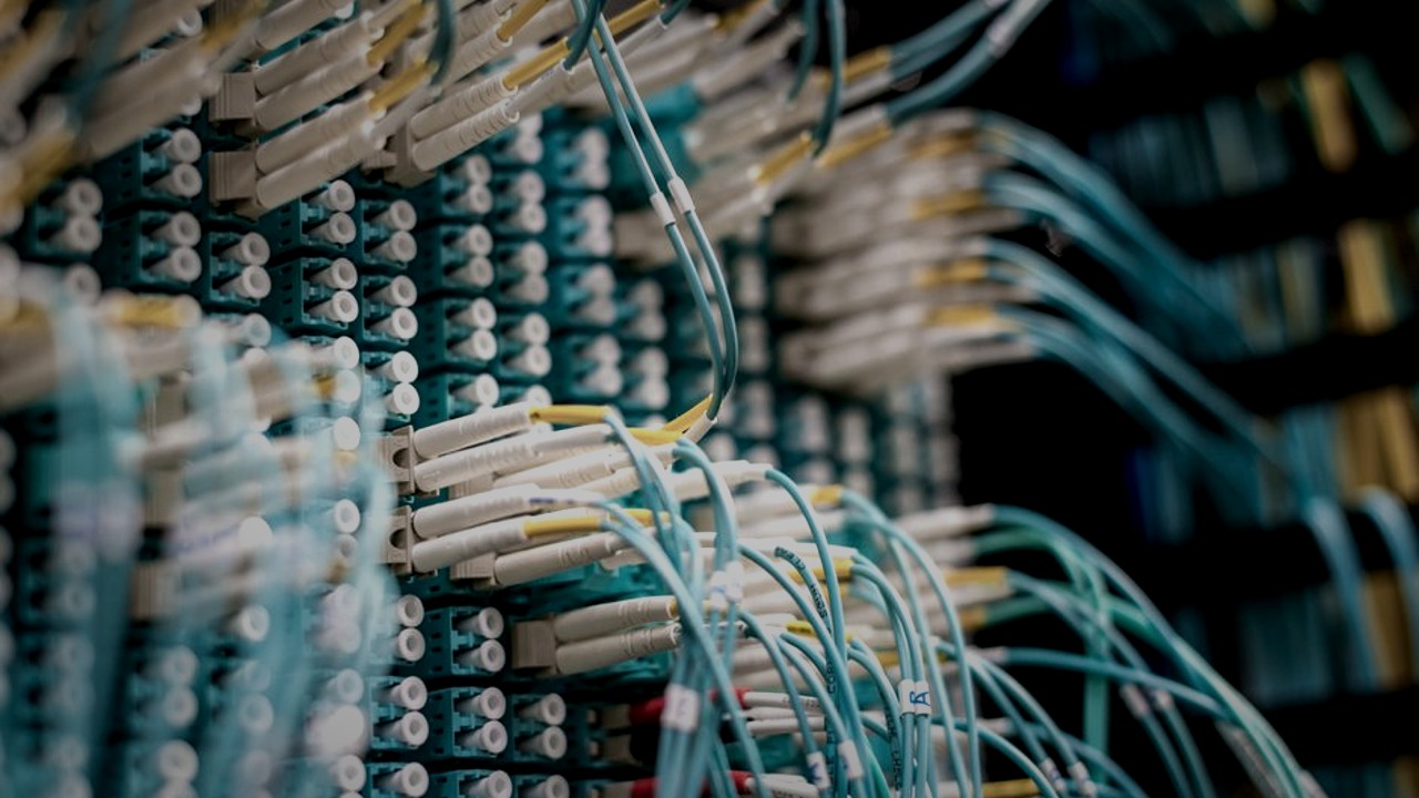 Shallow-focus network cables under low-key lighting, illustrating municipal cybersecurity