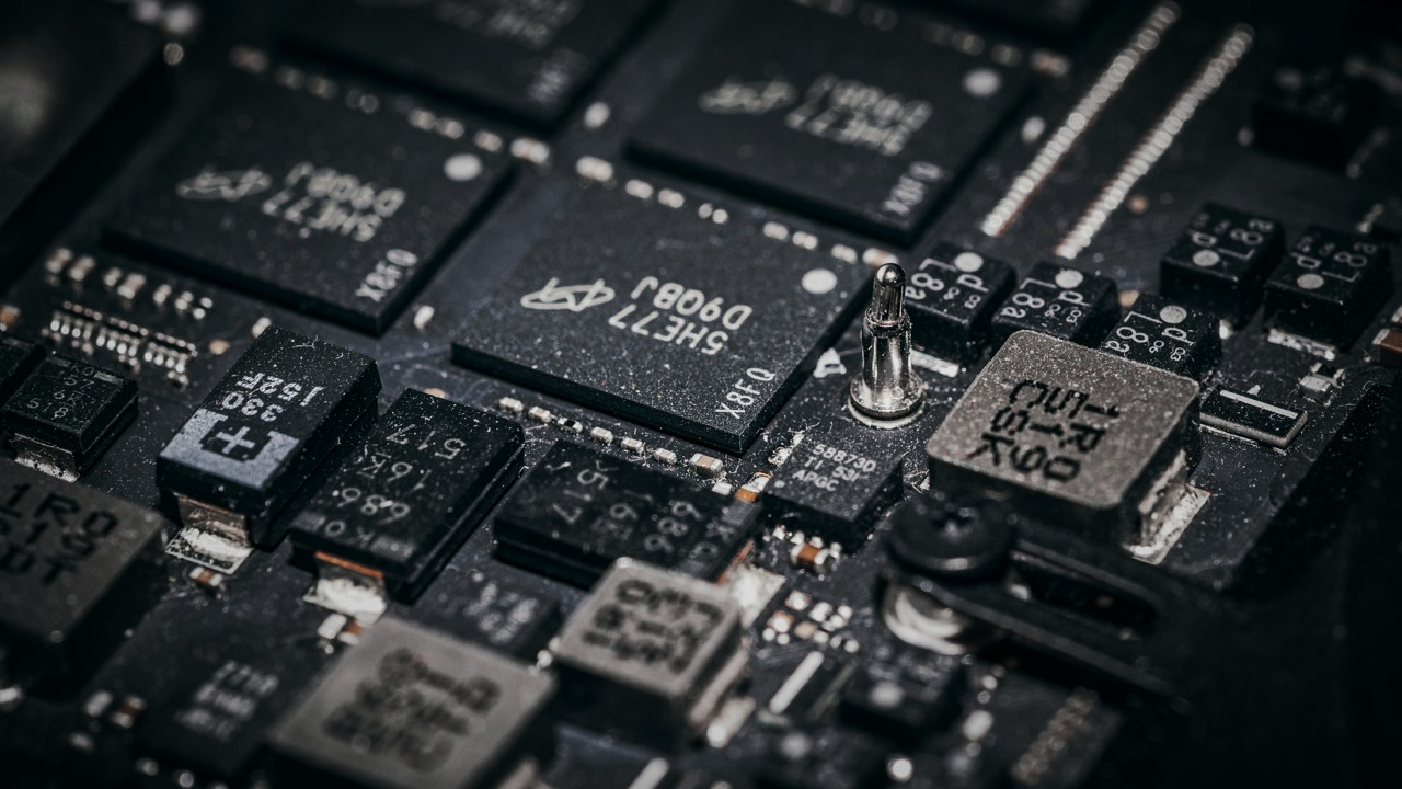 Moody macro photograph of electronic microchips, illustrating on-device computation; not the Infineon pilot module